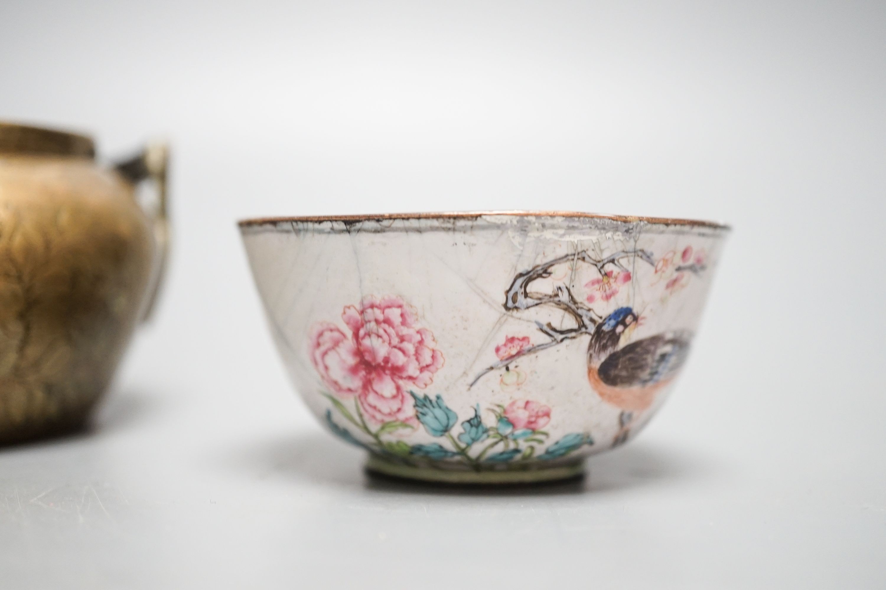 A Chinese bronze hand warmer, 11.3cm and an 18th century Chinese Canton enamel cup